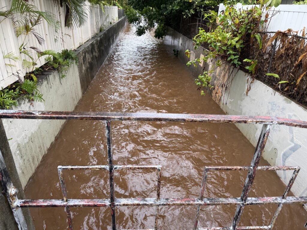 Brown water running at full strength down a drainage canal in Kāhala, Honolulu on Friday March 13.