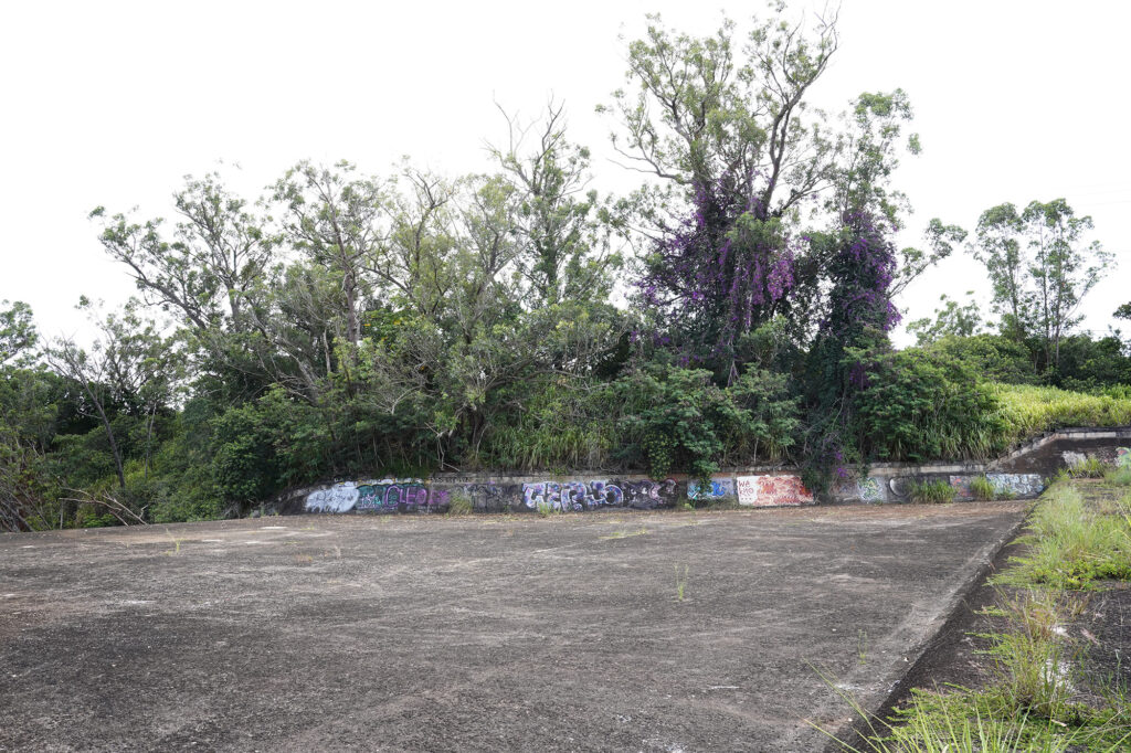 A view of the makai said of the Wahiawā Dam where the outflow of the Wahiawā Reservoir (Lake Wilson) becomes Kaukonahua Stream Monday, Aug. 5, 2024, in Wahiawā. (Kevin Fujii/Civil Beat/2024)