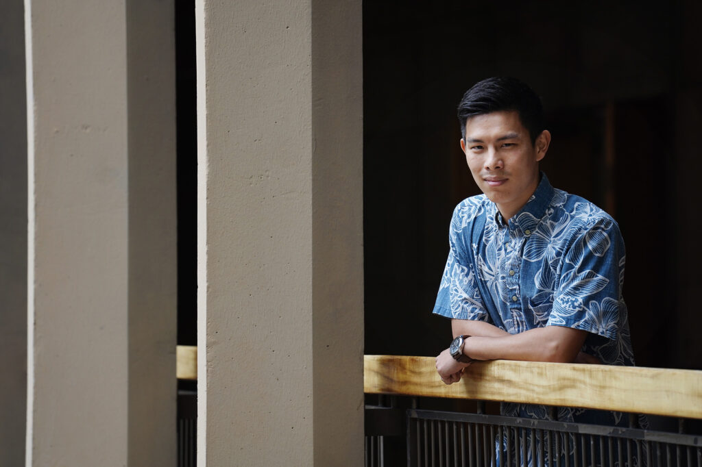 A portrait of Hawaiʻi State Representative Jackson Sayama is photographed with the 4th floor columns and a dark background Tuesday, March 17, 2026, at the Capitol in Honolulu.