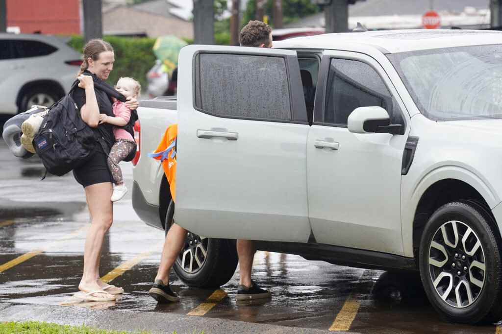 Charlotte and Alana Hayward get a ride to a friends house after their Waialua home flooded on the North Shore  Friday, March 12, 2026, in Wahiawā. (Kevin Fujii/Civil Beat/2026)