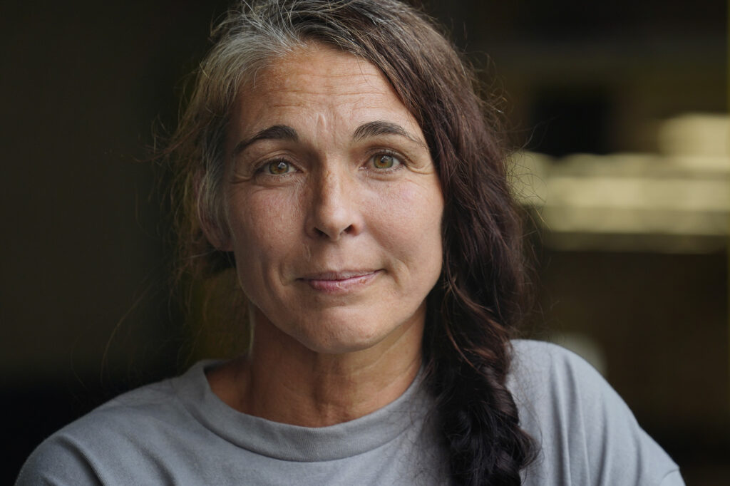 Sarah Ghio walked 1.6 miles through deep water after her North Shore plot of farm land flooded Friday, March 20, 2026. She is photographed at temporary shelter at Leilehua High School in Wahiawā. (Kevin Fujii/Civil Beat/2026)