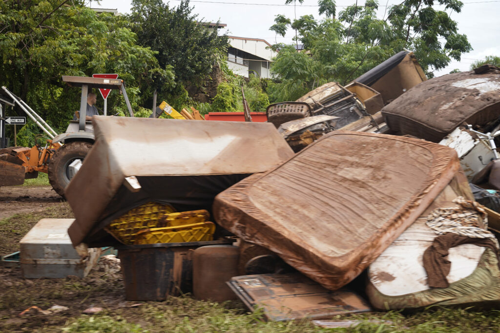 The traffic circle at Farrington Highway and Goodale Avenue has become a dumping ground as clean up begins Sunday, March 22, 2026, in Waialua. (Kevin Fujii/Civil Beat/2026)