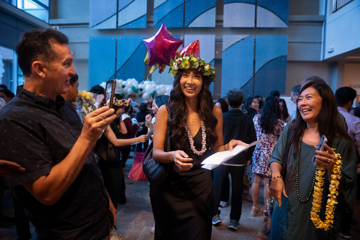 John A. Burns School of Medicine fourth-year student Kirra Borrello, center, celebrates her match to UCLA with her parents Adam Borrello, left, FaceTiming with her sister Adri Borrello, and mother Karianne Borrello, right, on Friday, March 20, 2026, in Honolulu. Kirra will continue her medical training in internal medicine. UCLA Health encompasses multiple medical centers in Southern California. (Kevin Fujii/Civil Beat/2026)