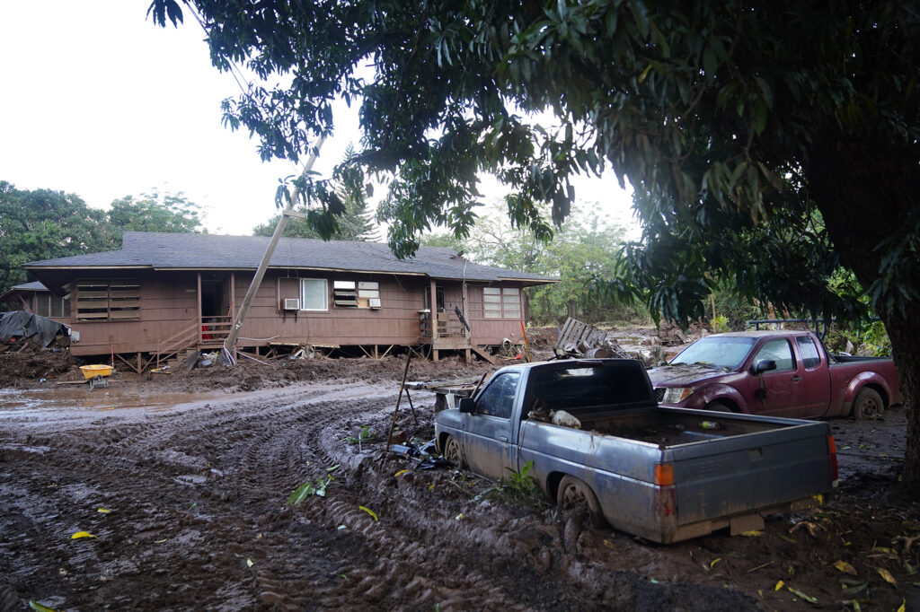 One of numerous Otake Camp homes and vehicles are photographed in deep mud Wednesday, March 25, 2026, in Waialua. The former plantation residential neighborhood received damage from the second Kona Low storm. (Kevin Fujii/Civil Beat/2026)