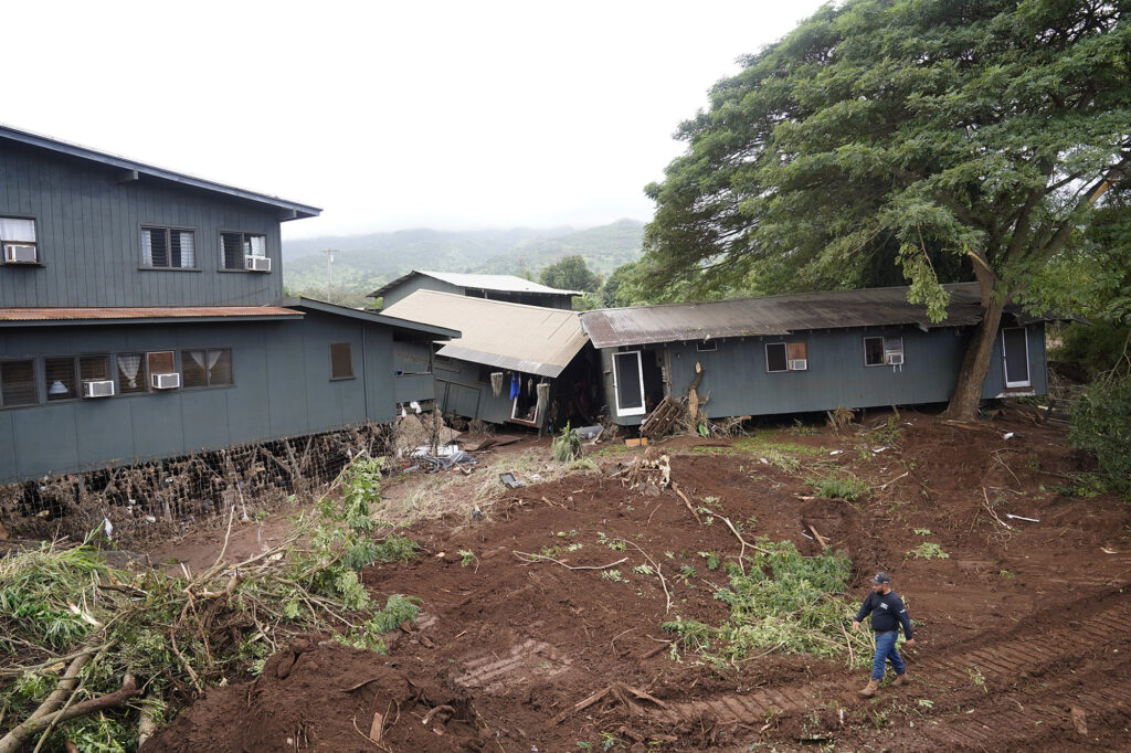 Waialua community leader Levi Rita walks near Otake Camp homes washed off their foundations Wednesday, March 25, 2026, in Waialua. The former plantation residential neighborhood received damage from the second Kona Low storm. (Kevin Fujii/Civil Beat/2026)