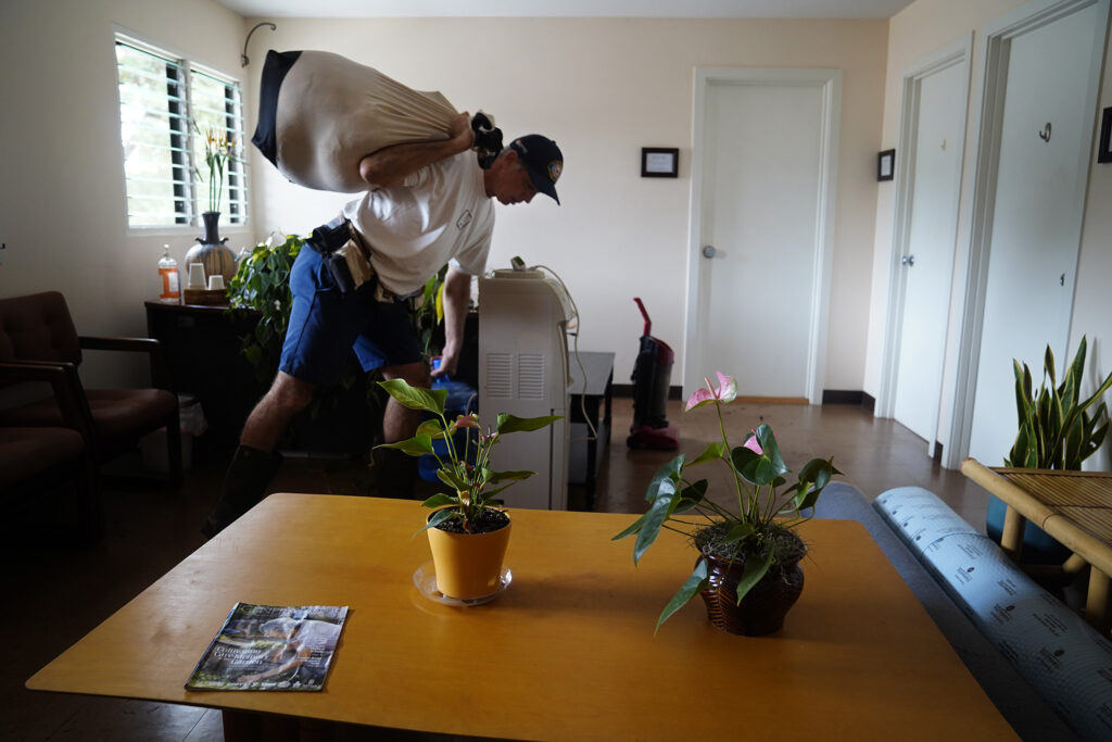 Ka‘ala Healing Arts building manager and tenant Jeff Ramos clears out some of his belongings Wednesday, March 25, 2026, in Waialua. The building is next to the Otake Bridge which flooded during the second Kona Low storm. (Kevin Fujii/Civil Beat/2026)