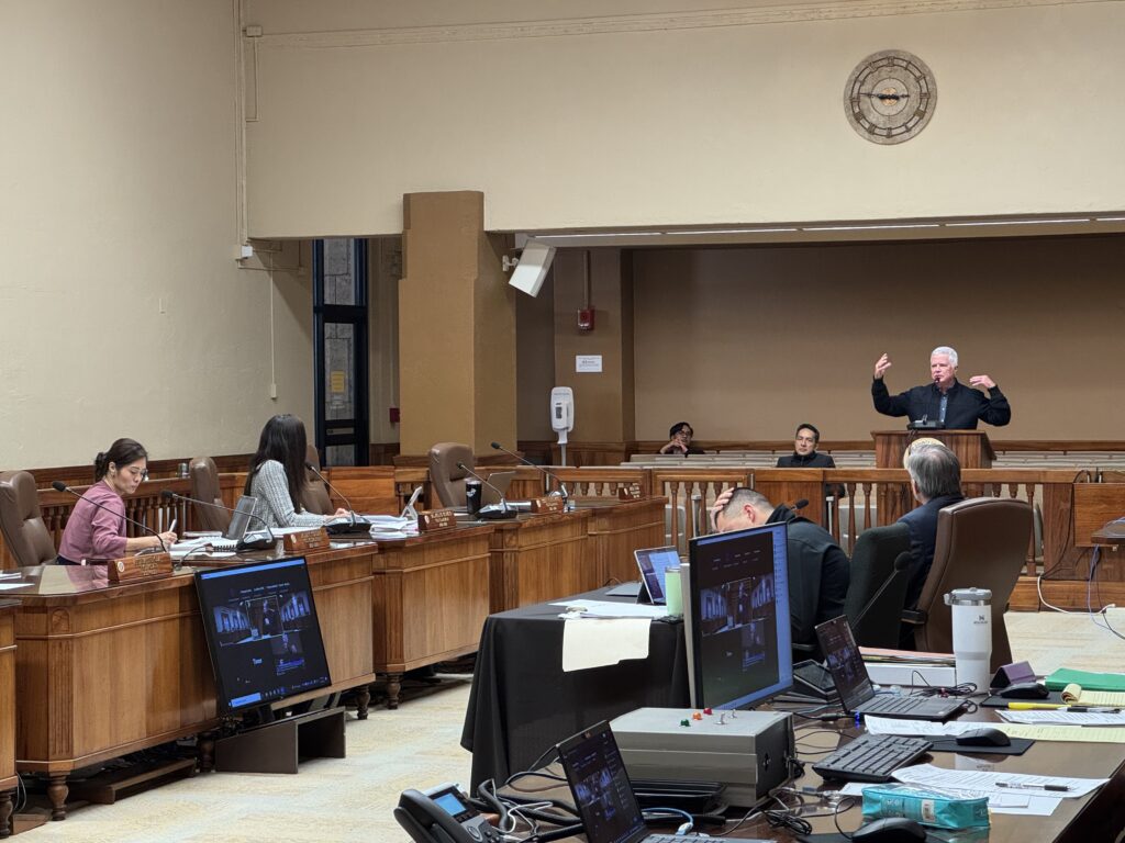 Mike Formby gesticulates as he defends the city administration's Kona Low response to city council members 