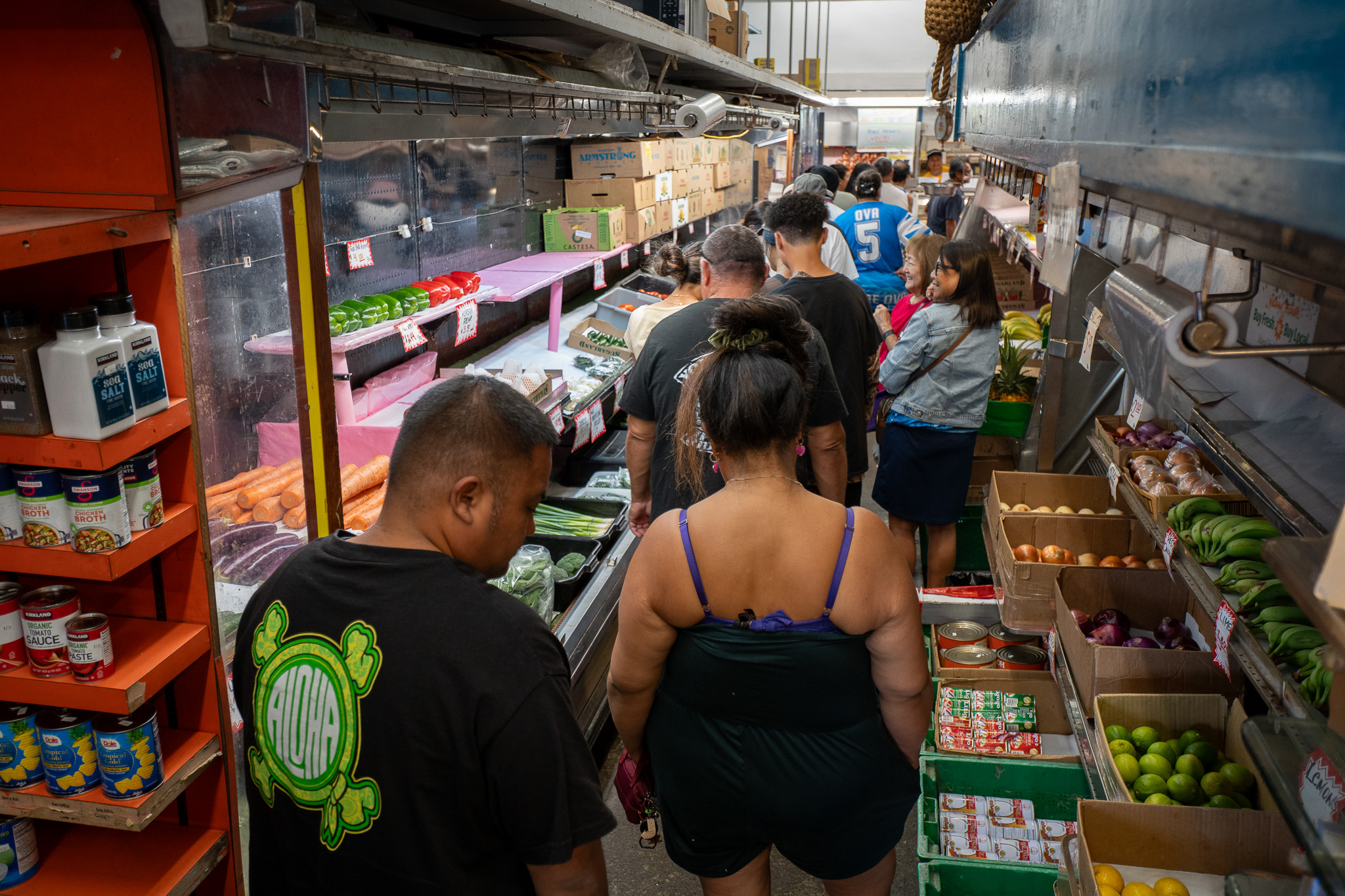 Customers line up for poke in the produce aisle at Tamashiro Market April 3, 2026. The much loved Kalihi institution closes April 30th. (Craig Fujii/Civil Beat/2026)