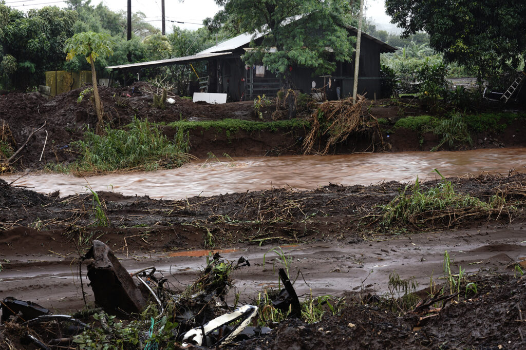 The Kaukonahua Stream remains in its banks and under Otake Bridge despite the mandatory evacuation of Otake Camp in Waialua Friday, April 10, 2026. The North Shore community is on edge after flooding from a recent Kona Low storm. (Kevin Fujii/Civil Beat/2026)