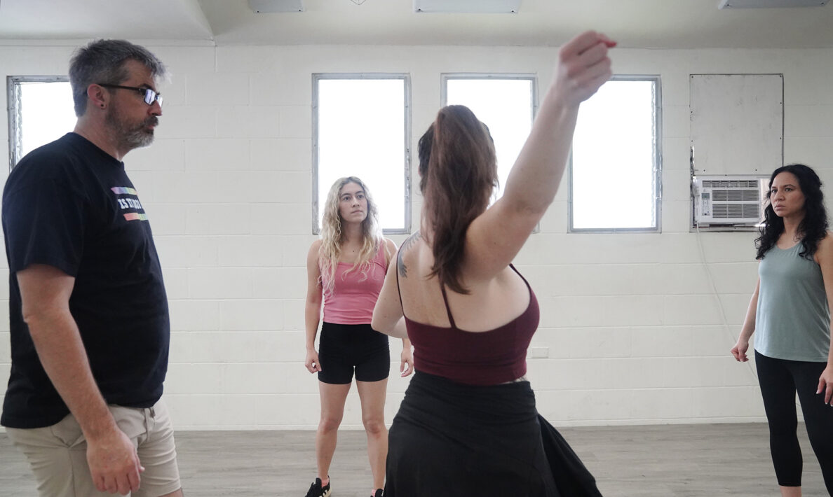 Teaching assistant Andrew Simmons, from left, student Miriam Yazdanpanahi, unarmed stage combat instructor Jasmine Haley Anderson, and student Stephanie Duarte  go though a choreographed scene Saturday, April 11, 2026, at Manoa Valley Theatre in Honolulu. Anderson teaches through Dueling Arts International. (Kevin Fujii/Civil Beat/2026)