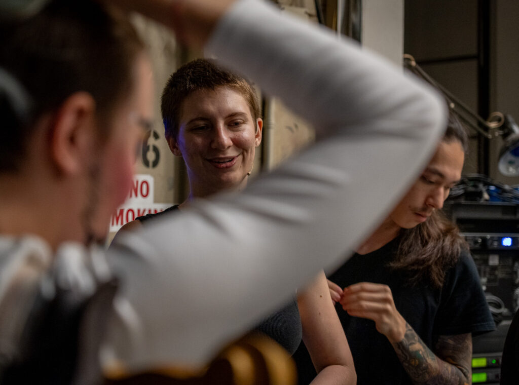 From left, Max Winig, Ella Ziel and Evan McCarty prepare for rehearsal backstage at the Kennedy Theatre April 16, 2026. The trio are part of the cast and crew of Panji and the Lost Princess. (Craig Fujii/Civil Beat/2026)