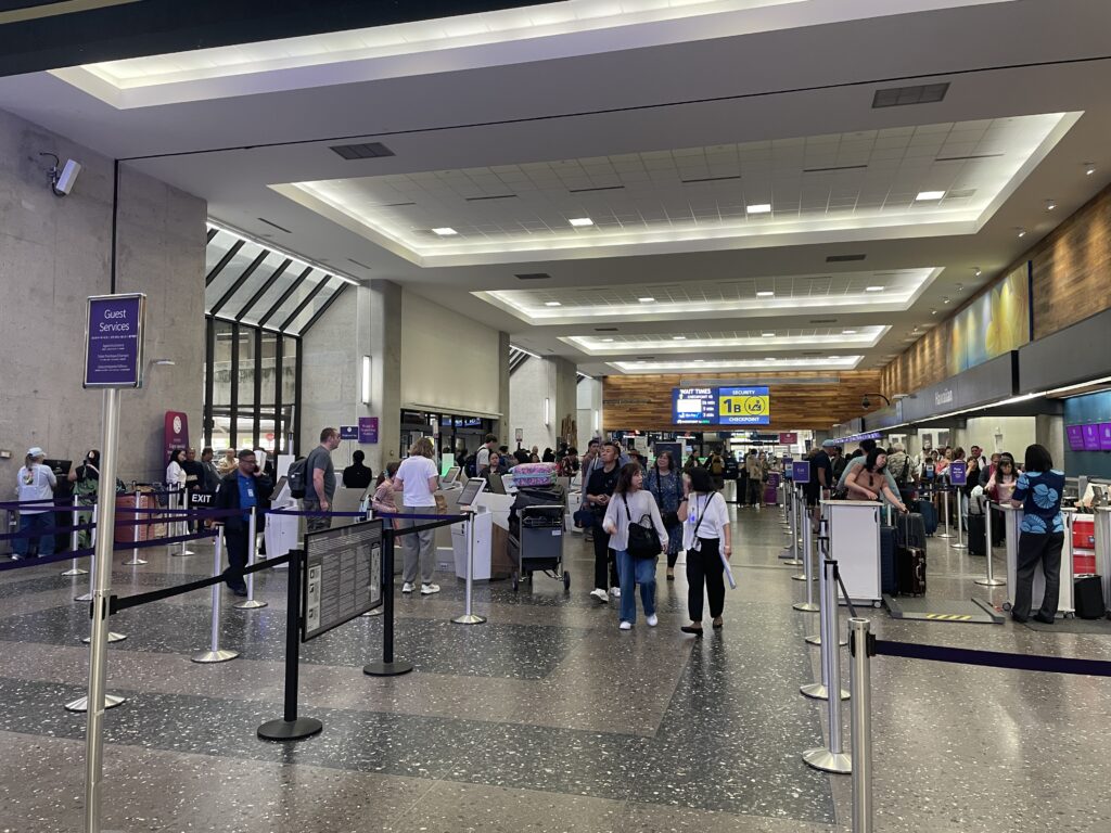 People in an airport departure lounge.