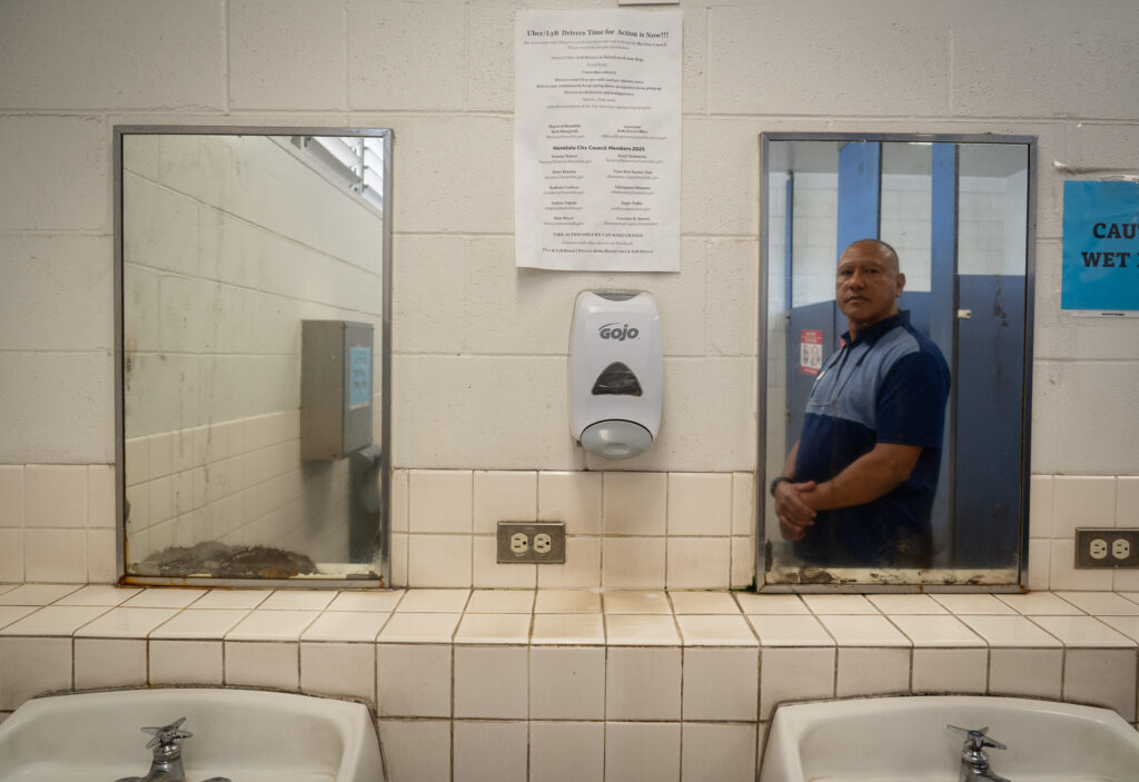 Rideshare driver Felix Fernandez saw this letter urging drivers to take action in the bathroom at the rideshare drivers parking lot at Daniel K. Inouye International Airport, and was moved to rally drivers to push for pricing transparency and pay minimums from Uber. (Craig Fujii/Civil Beat/2026)