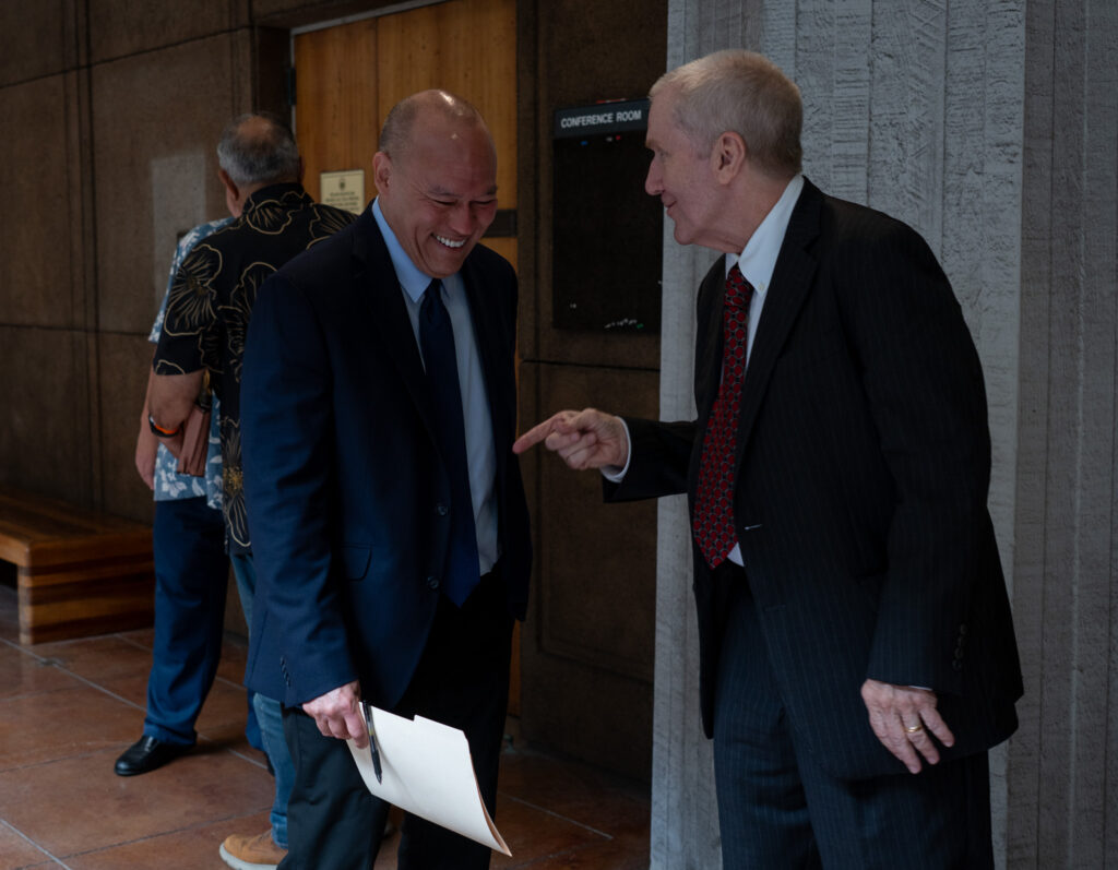Hawai'i Chief Justice nominee Vladimir Devens shares a laugh with Honolulu Prosecuting Attorney Steve Alm during a break in his confirmation hearing at the Capitol April 22, 2024. A vote by the Senate Judiciary Committee is expected April 24. (Craig Fujii/Civil Beat/2026)