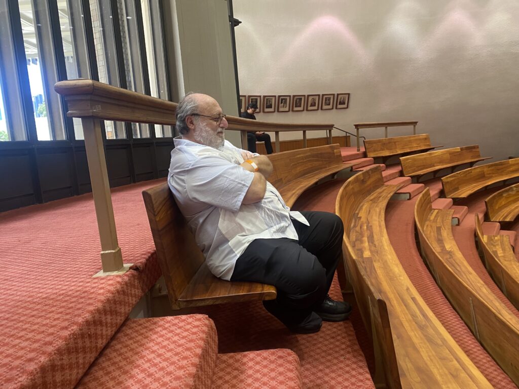 Ali Silvert watches with his arms crossed as the Hawaiʻi House of Representatives shelves a citizen petition he started urging them to investigate a possible case of corruption. (Chad Blair/Civil Beat/2026)