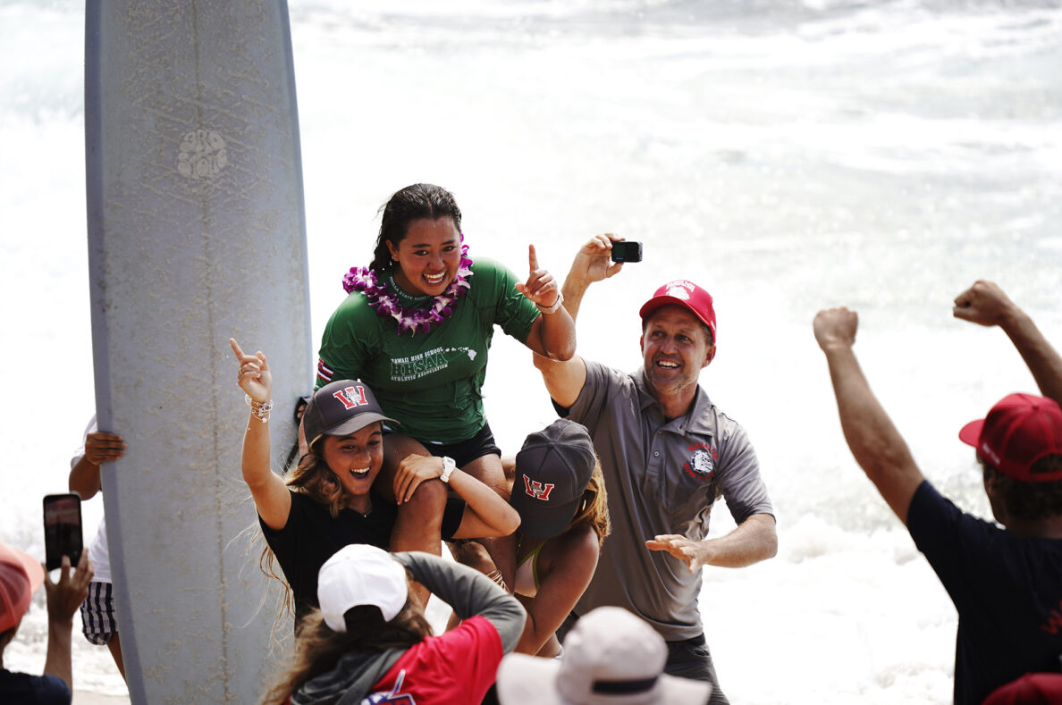 Hanae Rose of Waialua High School gets carried off the beach for winning the inaugural Hawaiʻi High School Athletics Association surfing state championships in girls longboard Saturday, May 2, 2026, at Hoʻokipa Beach Park in Pāʻia. (Kevin Fujii/Civil Beat/2026)