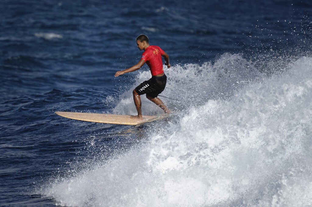 Micah Ah You of Kahuku High School competes in the inaugural Hawaiʻi High School Athletics Association surfing state championships boys longboard quarterfinals  Saturday, May 2, 2026, at Hoʻokipa Beach Park in Pāʻia. Ah You finished second in the boys final. (Kevin Fujii/Civil Beat/2026)