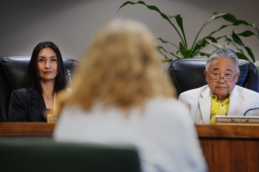 Big Island Invasive Species Committee’s Franny Brewer, center, addresses the Hawaiʻi County Council including members Ashley Kierkiewicz, left, and vice-chair Dennis “Fresh” Onishi Tuesday, May 5, 2026, in Hilo. (Kevin Fujii/Civil Beat/2026)