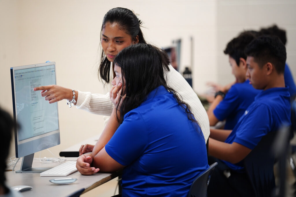Kūlia Academy teacher Aileen Abitong works with Sichang Spencer during a coding assignment for seventh graders Thursday, May 7, 2026, in Honolulu. (Kevin Fujii/Civil Beat/2026)