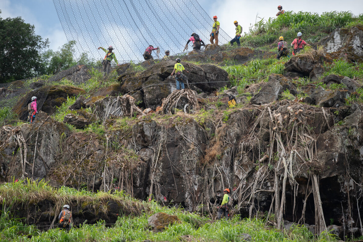 Ant-like workers cover the massive hillside above Waimea Bay May 17, 2026. The crew laid rockfall safety netting and the roadway was closed Sunday. (Craig Fujii/Civil Beat/2026)