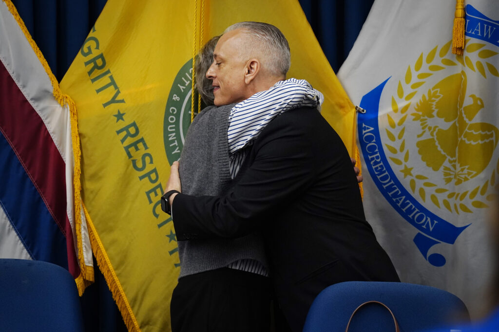 Honolulu Police Commission chair Laurie Foster hugs David Lazar after naming him the new chief of the Honolulu Police Department Wednesday, May 20, 2026, in Honolulu. (Kevin Fujii/Civil Beat/2026)