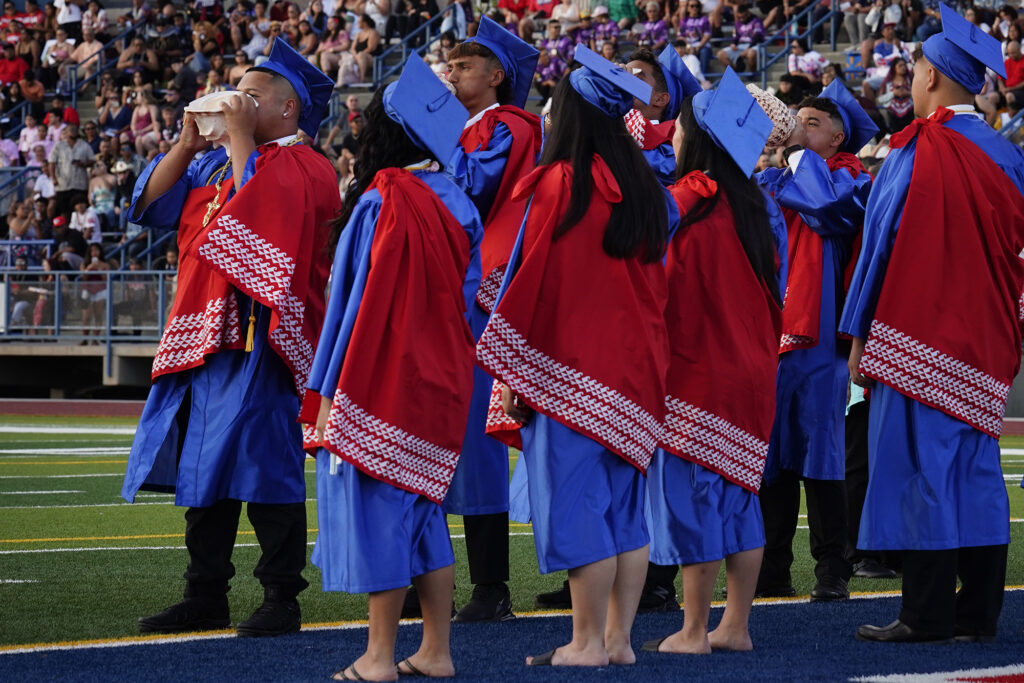 Pū, blowing of the conch shell, begins the Waiʻanae High School commencement ceremony Friday, May 22, 2026, in Waiʻanae. (Kevin Fujii/Civil Beat/2026)