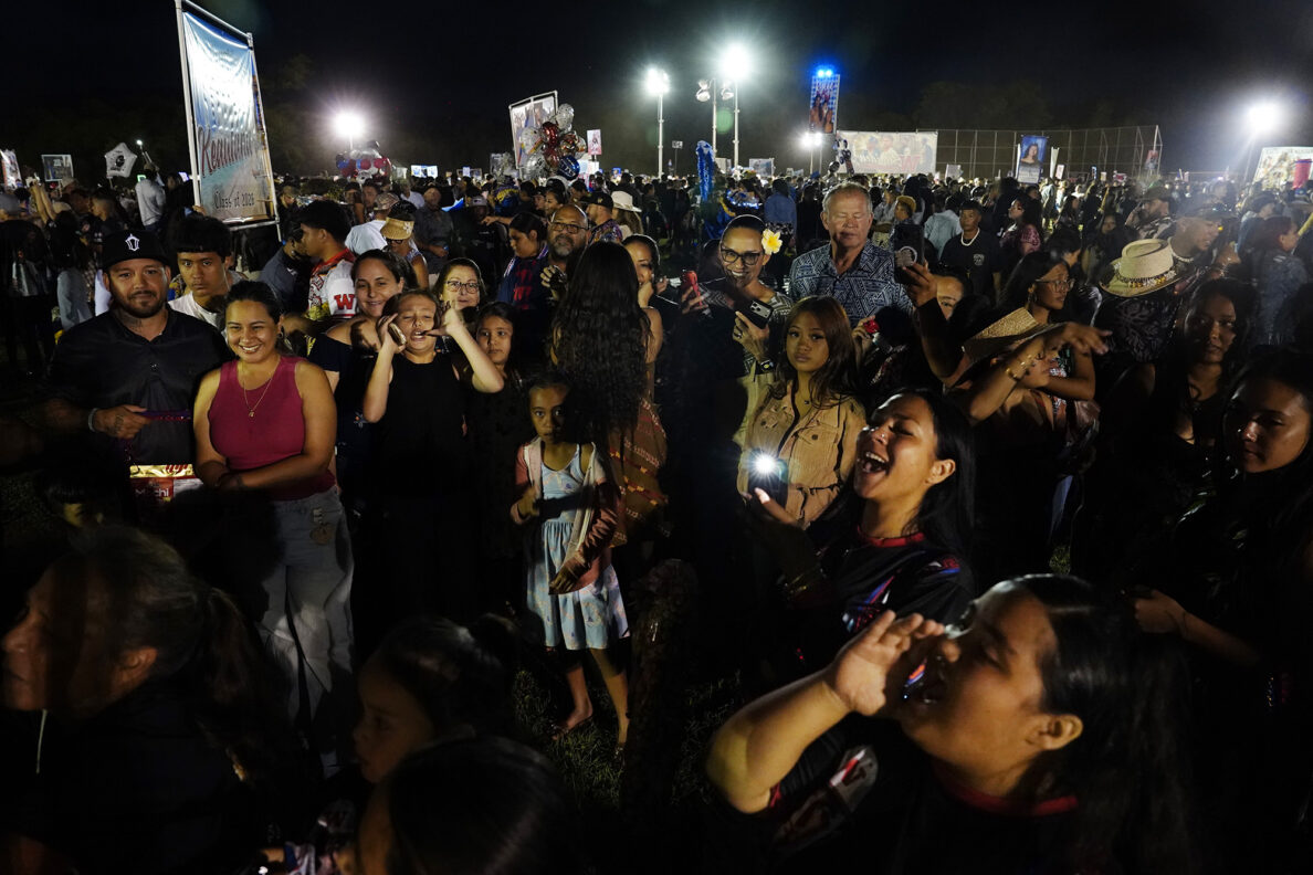 ʻOhana and friends give Waiʻanae High School graduate Kiare Ibarra a shout out after the commencement ceremony Friday, May 22, 2026, in Waiʻanae. (Kevin Fujii/Civil Beat/2026)
